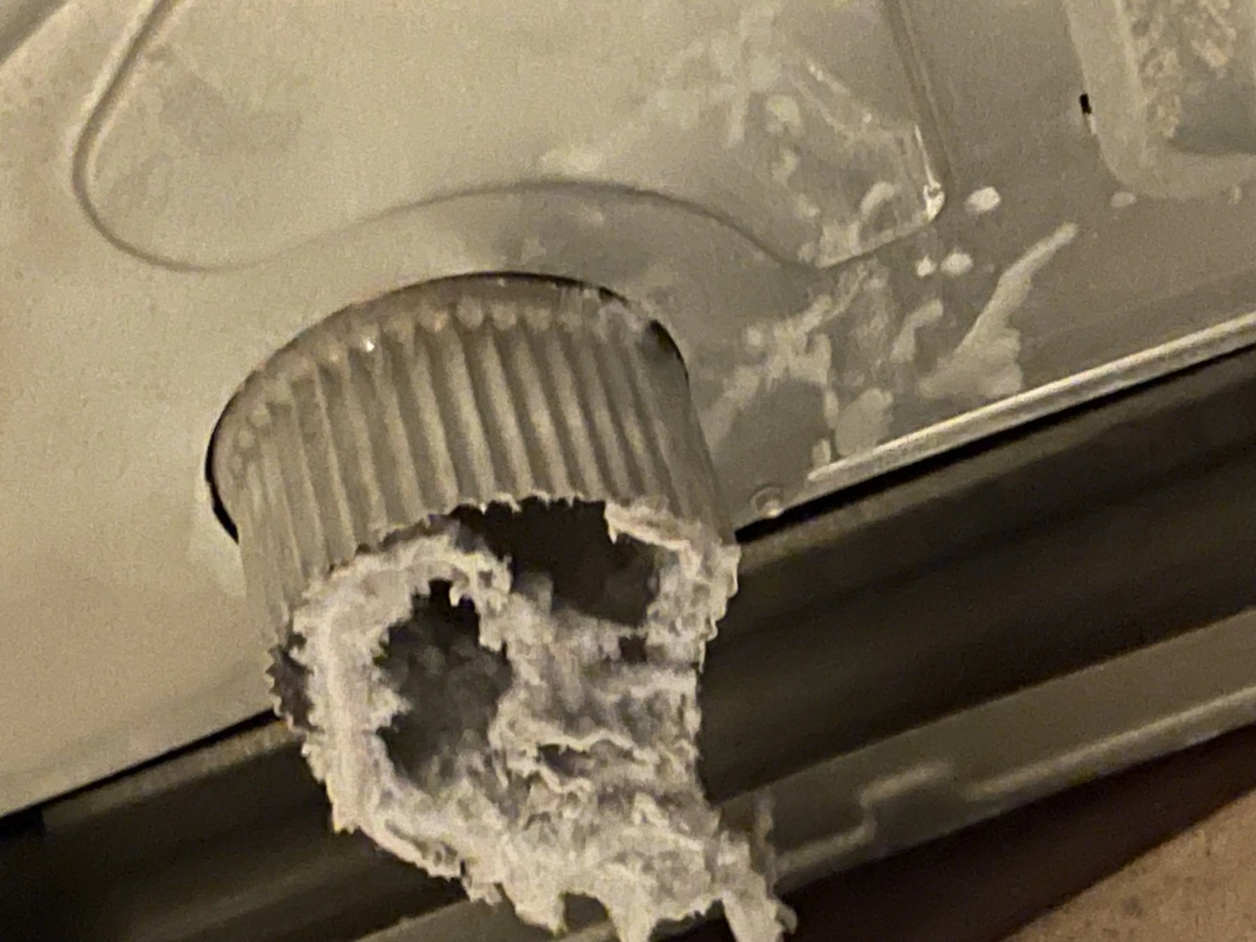 Close view of lint buildup inside a dryer vent duct.